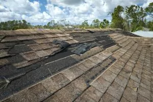 Damaged shingles on Dallas TX home after hail storm