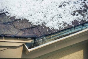 inspecting hail damage during a roof insurance claim in Dallas, TX